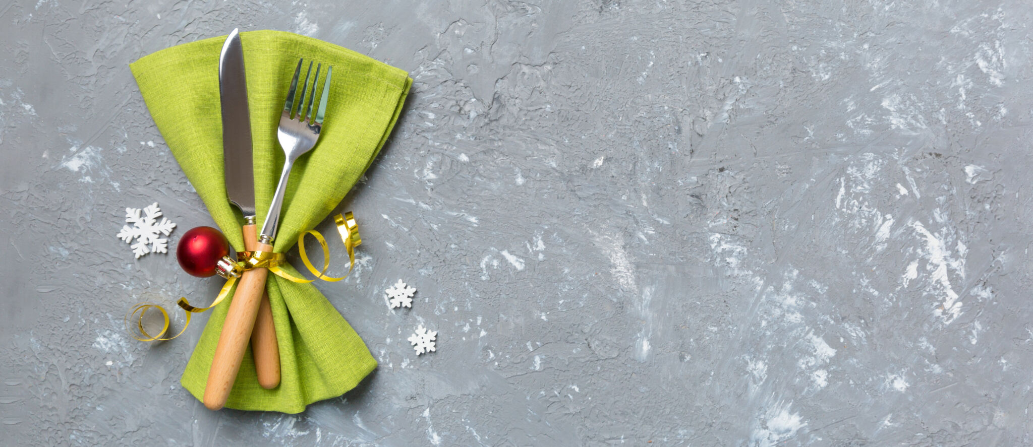 Christmas table place setting with knife, napkin and fork. Holidays new year background with copy space.